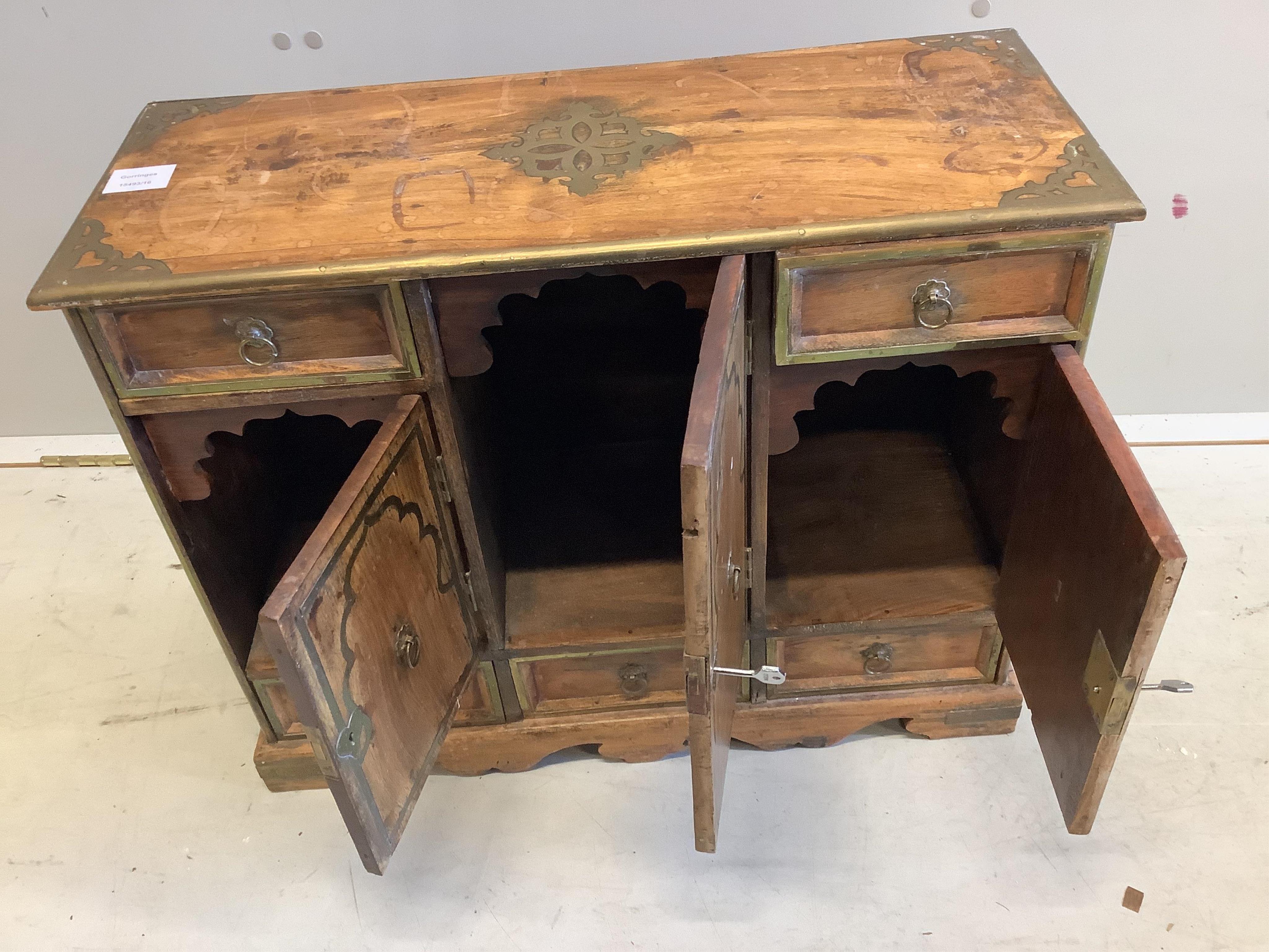 An unusual small Continental brass inlaid cabinet, fitted with three cupboards and five drawers, width 62cm, depth 25cm, height 50cm. Condition - fair